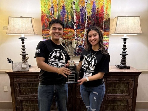 CAMP Students Heron and Paloma holding SLC Trophy